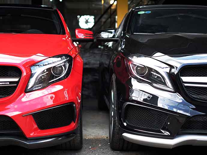 A red Mercedes and a black Mercedes side by side A red Mercedes and a black Mercedes side by side