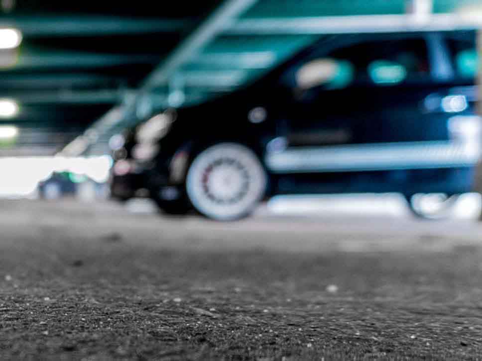 A blurry Abarth parked in an indoor car park