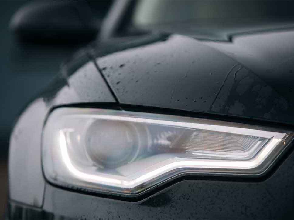 Headlight of Audi on a rainy day