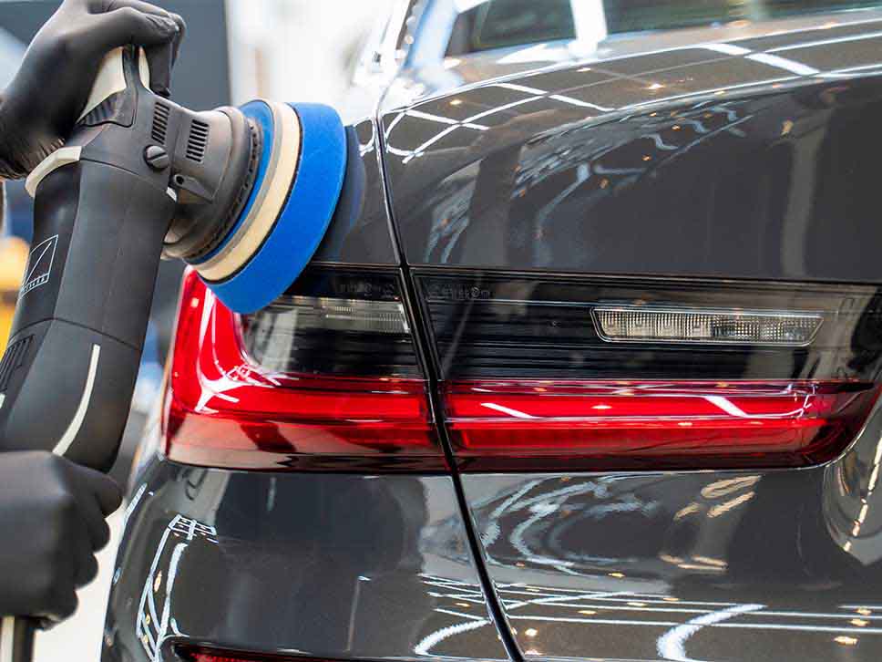 Grey BMW rear getting polished