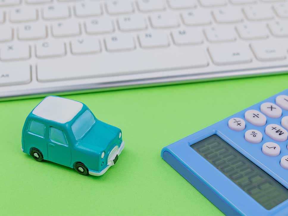 Car sales desk with a toy car and a calculator