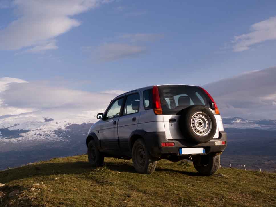 Daihatsu off roader with a mountain view