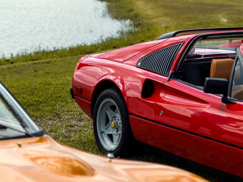 Vintage Ferrari parked on grass rear view