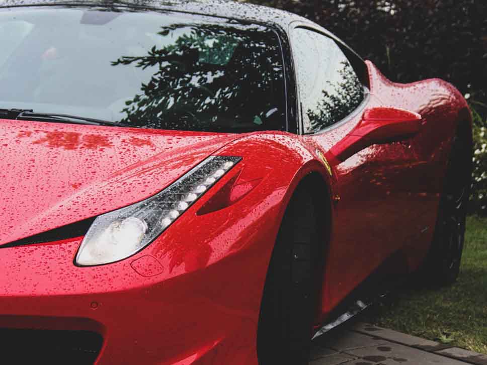 Side view of wet Ferrari