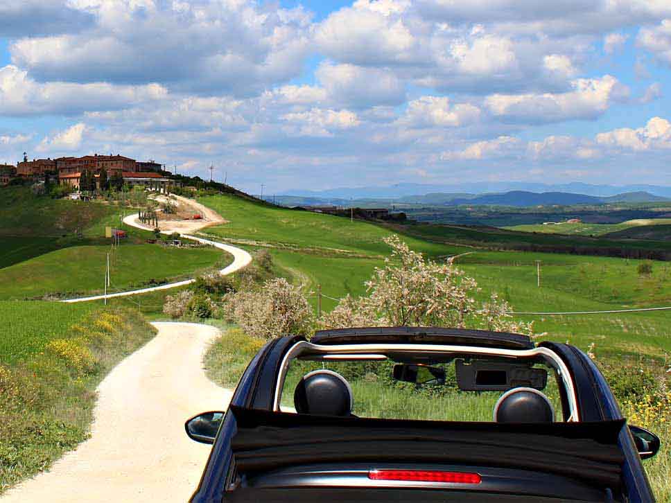 Convertible Fiat with roof down in the Tuscan hills
