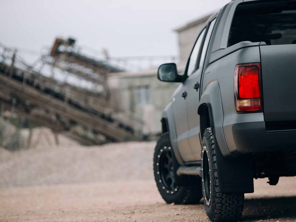 Ford pickup rear view on gravel