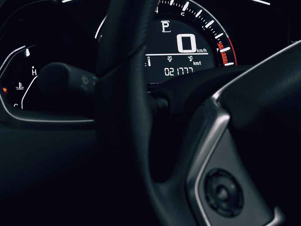 Honda speedometer behind steering wheel view