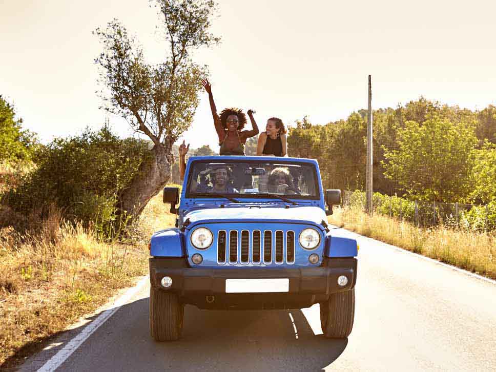 Friends enjoying them self in a open roof Jeep