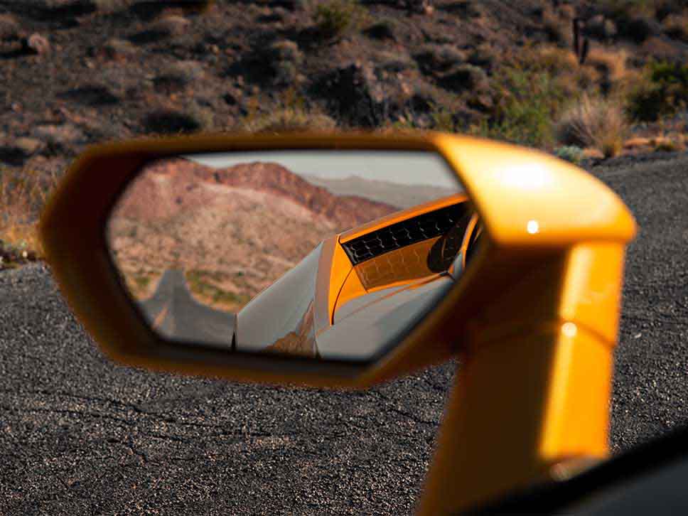 Lamborghini side mirror view of scenery
