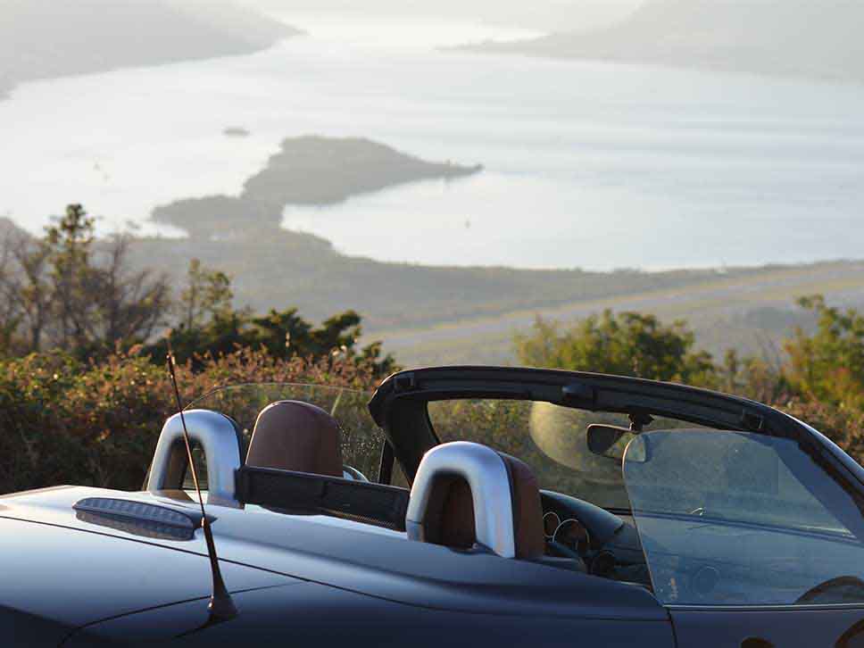 Convertible Mazda with roof down on scenery