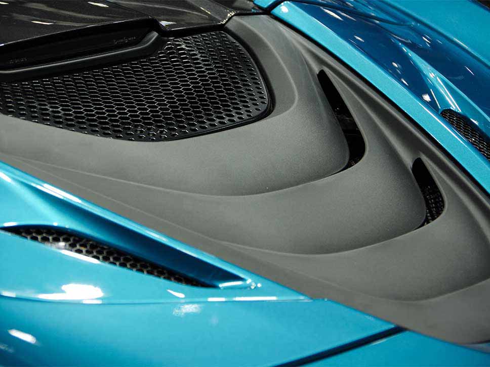 Rear engine air outtake on a blue McLaren
