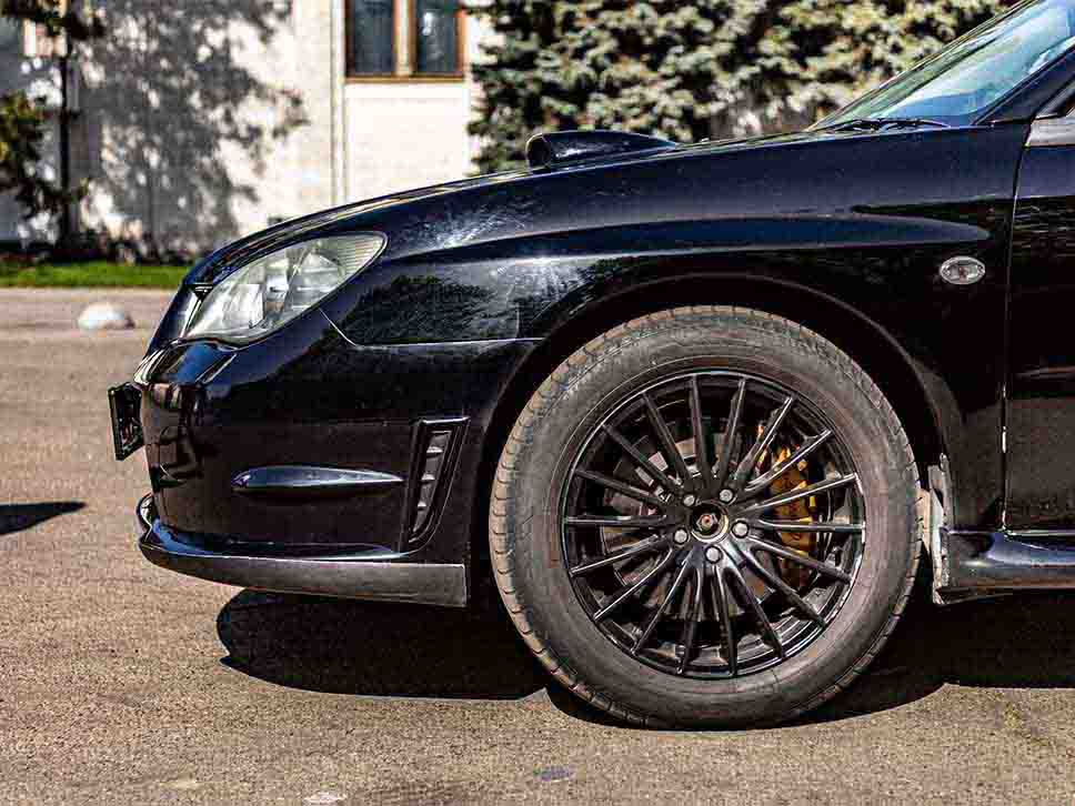 Front side profile of a black Subaru Impreza